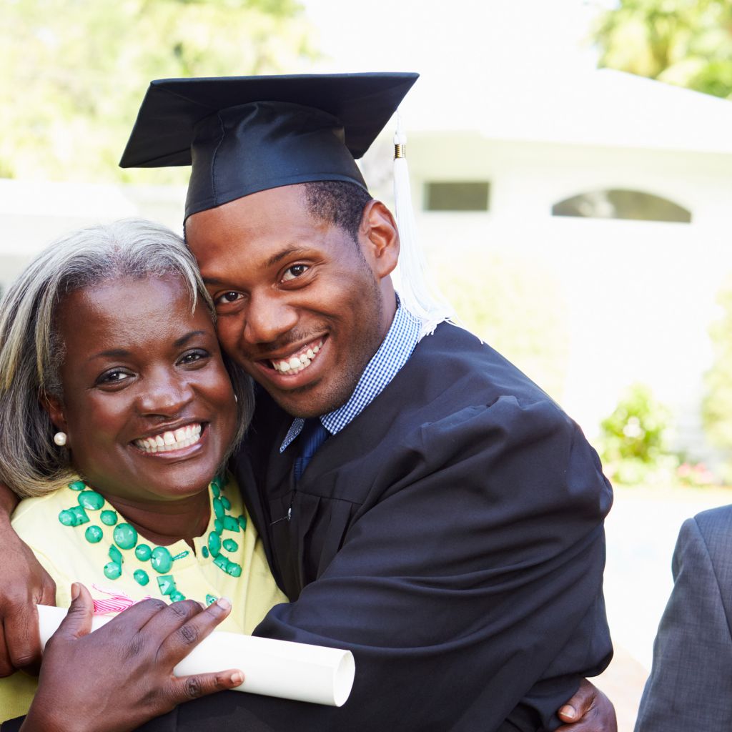 African American student celebrates graduation with parents